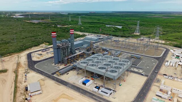 Aerial View Of Industrial Power Plant With Smokestacks, Cooling Fans, And Electrical Substation In The Dominican Republic.