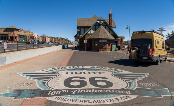 Flagstaff, Arizona, USA - April 5th 2026: Road painting commemorating the 100 years of route 66, with the Flagstaff train station in the background