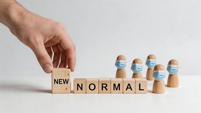 Business man hand holding wooden cube with word new writing next to other blocks forming normal phrase