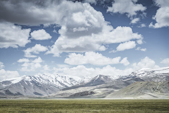 Mountain landscape with a view of a rocky mountain ridge with snow and glaciers in the highlands of Tajikistan in the Pamirs. A panorama of the Tien Shan Mountains for background