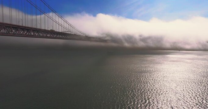 25th April Bridge Lisbon Portugal aerial disappearing into fog above the Tagus River