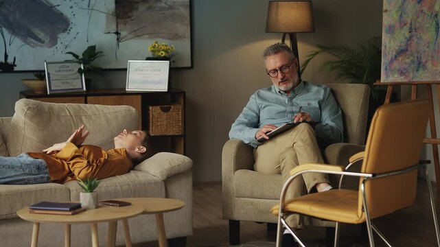 Male psychologist listening to sad female patient, mental health therapy