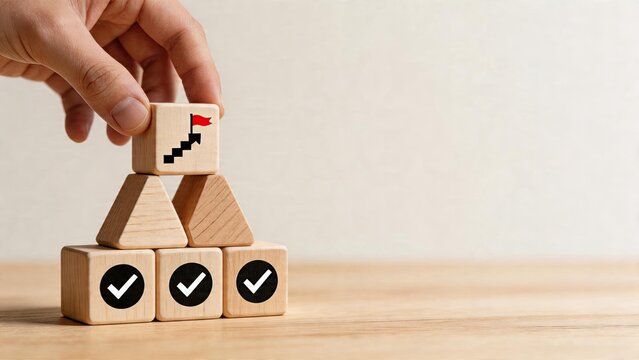 Business man hand placing wooden block with flag on top of pyramid strategy success goal achievement planning growth teamwork corporate management marketing concept