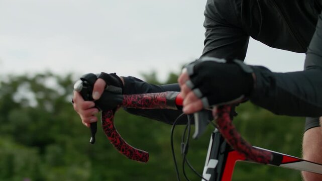 Close-up of a cyclist doing cycling. Man training, workout and healthy lifestyle.