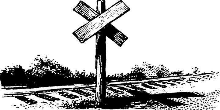 Railroad crossbuck sign standing beside tracks in field