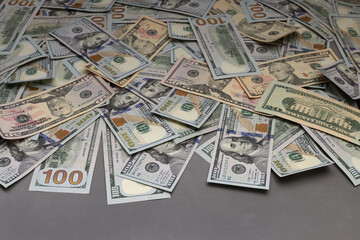 Fototapeta premium American cash banknotes on gray table for money background.