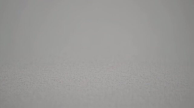 Close-up view of a light gray textured surface