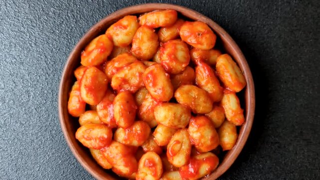 Homemade potato gnocchi with Bolognese sauce, seasoned with salt and spices, ready for lunch. Gnocchi with sauce as a food background for your design