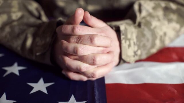 A US Army soldier sits at a negotiating table.