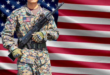 Obraz premium United States of America flag with soldier holding assault rifle