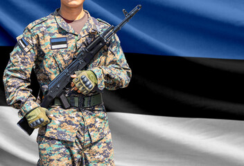 Fototapeta premium Estonia flag with soldier holding assault rifle