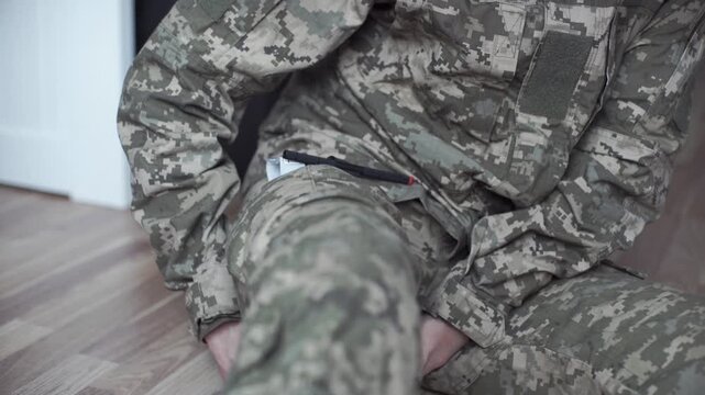 A combat medical tourniquet stops blood flow during first aid.