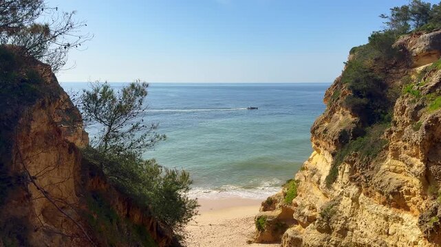 Slide view over empty Pinhao Beach in Lagos Coastline, Algarve, Portugal Aerial wide slide overview shot