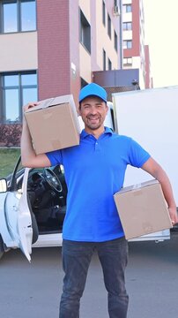 A courier with boxes near a white van preparing to leave for orders. Mockup, free space. Delivery concept, small business