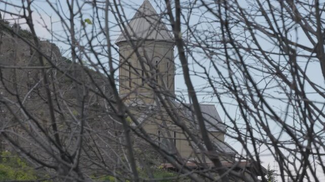 Ancient Georgian Church Viewed Through Bare Winter Branches