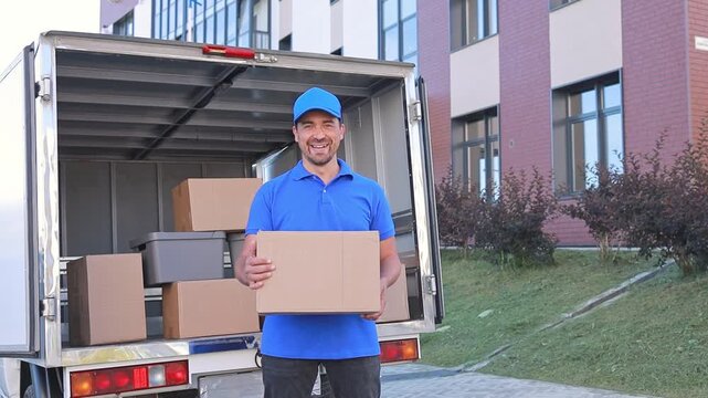 A man in a uniform is smiling and standing next to a delivery van. Courier service, transportation services.