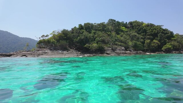 Tranquil underwater scene showing vibrant coral formations coastal scene featuring clear turquoise waters and a lush green island, relaxation themes, nature articles