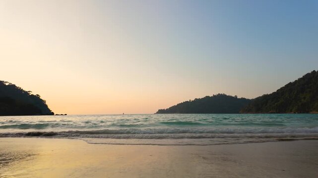 Serene soothing beach scene at sunset slow motion, featuring calm waters and distant hills, travel articles, relaxation themes, nature promotions, This image captures tranquility and natural beauty