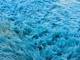 Fototapeta premium Close-up of a soft and fluffy light blue faux fur texture, perfect for cozy backgrounds and interior design themes.