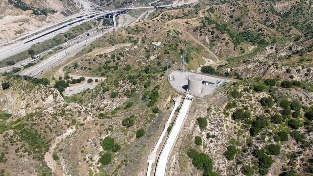 Wide Aerial View of the Los Angeles Aqueduct Cascades and Infrastructure in the Santa Clarita Foothills