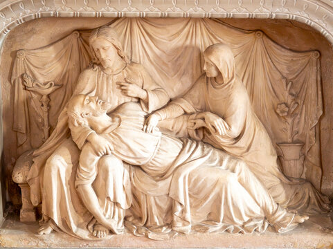 Stone bas relief (19th century) of Death of Saint Joseph surrounded by Mary and Jesus.