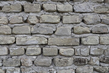 Fototapeta premium An old grey wall with bricks