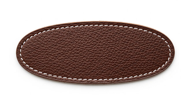 Dark brown leather oval patch with white stitching isolated on white background for premium clothing branding
