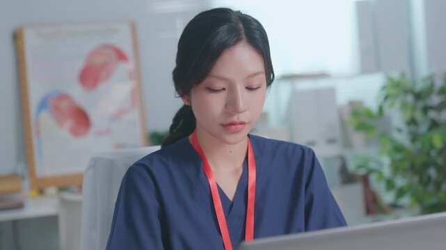 Doctor entering electronic medical records. Medical, asian woman working with computer in medical consultation at hospital. which are recording diagnoses and patient symptoms. Healthcare and medicine
