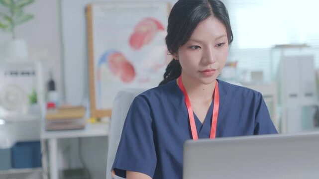 Doctor entering electronic medical records. Medical, asian woman working with computer in medical consultation at hospital. which are recording diagnoses and patient symptoms. Healthcare and medicine
