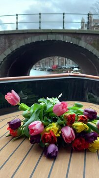 Amsterdam, Netherlands, canal, canals, tulips, bouquet, flowers, boat, moving boat, boat ride, travel, tourism, Europe, Dutch houses, architecture, cityscape, water, reflection, colorful, spring, summ