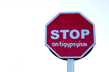Obraz premium stop antigypsyism. social issues concepts. road sign on asphalt with written text