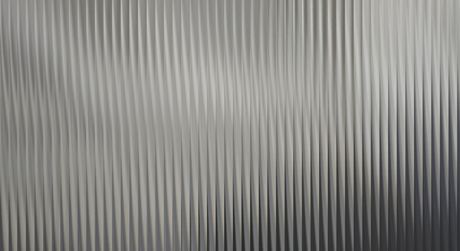 A close-up view of a metallic surface with vertical ridges and a gradient of gray tones