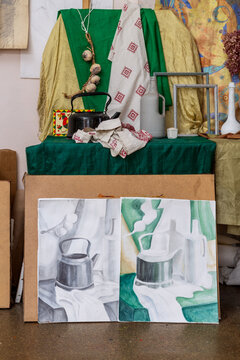 Watercolor drawing from life. A still life study with a teapot and fabric.