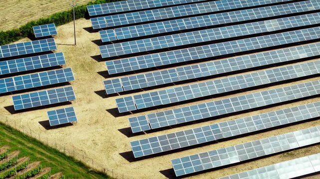 Solar panel array in structured rows, aerial close-up of renewable energy field supporting decarbonization and climate change