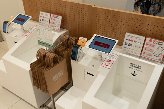 Self-checkout stations with paper shopping bags