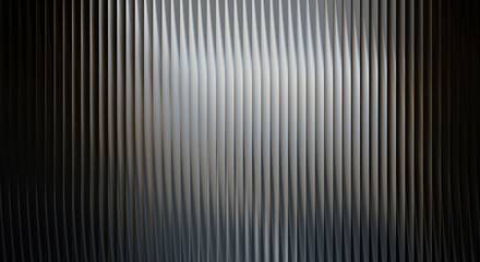 Obraz premium A close-up view of a sleek metallic surface with vertical lines and a spotlight shining on it