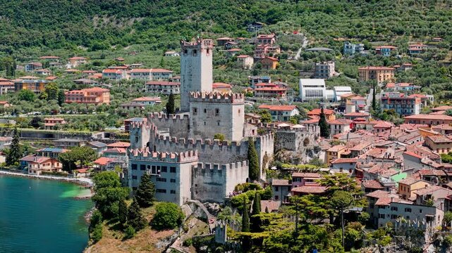 Scaliger Castle in Malcesine on Lake Garda. Medieval stone fortress on cliff with tower and fortified walls in northern Italy
