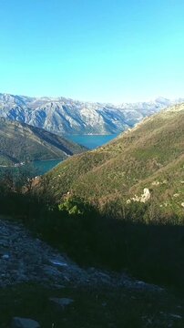 Panoramic view of Bay of Kotor with Verige Strait, Adriatic Sea, and forested slopes of Vrmac mountain. Captures sweeping grandeur of coastal wilderness and reward of elevated hiking trails.