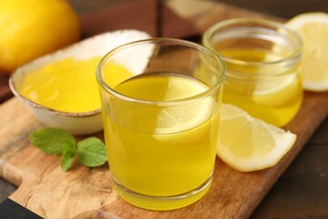 Fototapeta premium Tasty lemon jelly served on wooden table, closeup