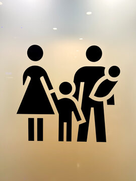 Black symbols on a glass door leading to a family room where babies and young children can be changed.