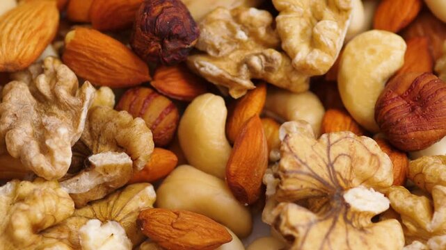 Detailed shot of various nuts mix featuring walnuts, cashews, almonds and hazelnuts. High quality organic product for healthy nutrition and snacking