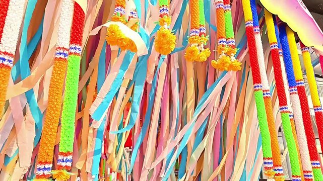 Decorative paper and floral Songkran ornaments blowing in the wind, Thai Siam Buddhist New Year Celebration, Religious Cultural Decor, Slow Motion