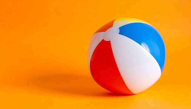 Colorful Beach Ball on Orange Background Representing Summer Fun Play and Lifestyle Photography