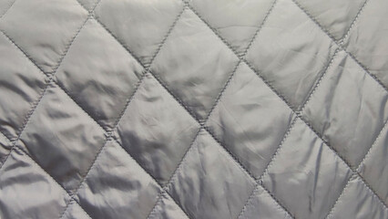Naklejka premium quilted fabric texture gray stitched pattern textile material closeup