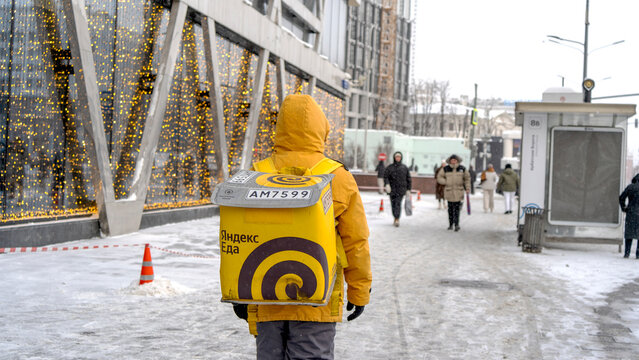 Moscow, Russia, September 04, 2025: A Yandex delivery courier walks down a street in Moscow