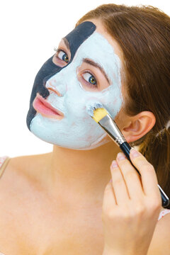 Girl black mask on half face apply white mud