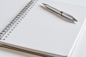 Naklejka premium A metallic mechanical pencil rests on a clean, blank white spiral-bound notebook page.