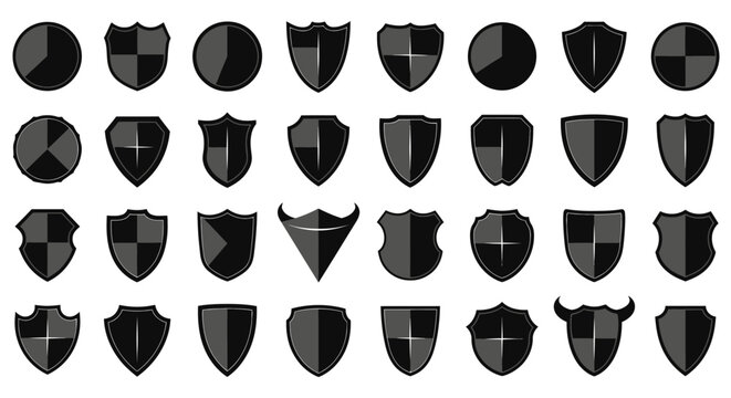 Collection of black shield icons in various shapes and designs on white background for protection and security concepts