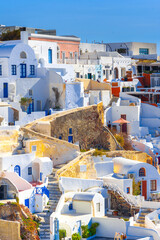 Fototapeta premium Oia town on Santorini island, Greece. Traditional and famous houses and churches with blue domes over the Caldera, Aegean sea