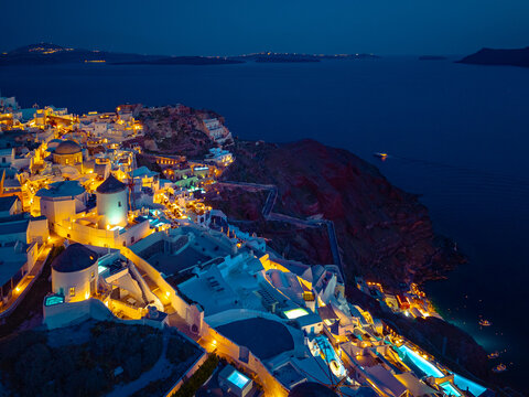 Aerial view of Oia town and caldera on Santorini island ay night, Greece. 